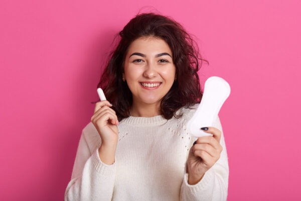 cheerful-energetic-female-standing-with-sanitary-pads